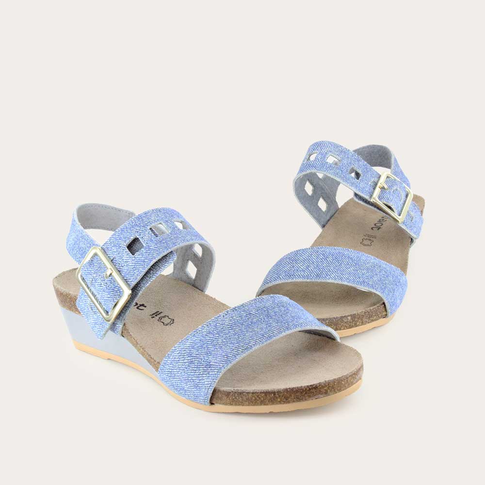 Pair of blue denim wedge sandals, featuring two straps and a metallic buckle with a cork footbed