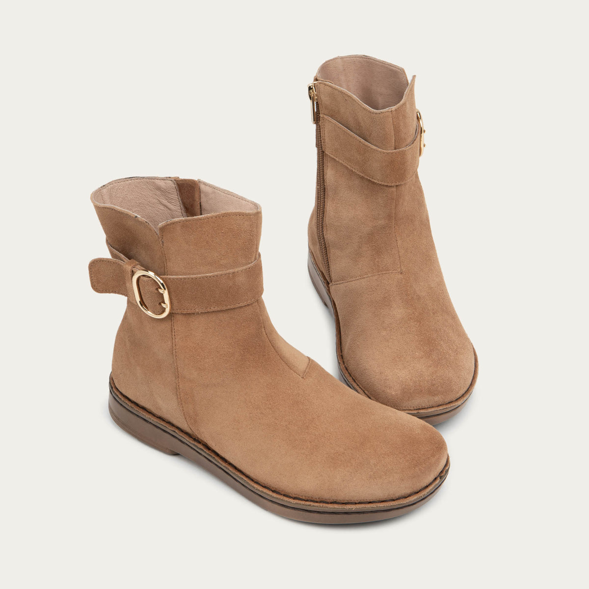 Pair of tan calf boots with a simple strap and buckle detail