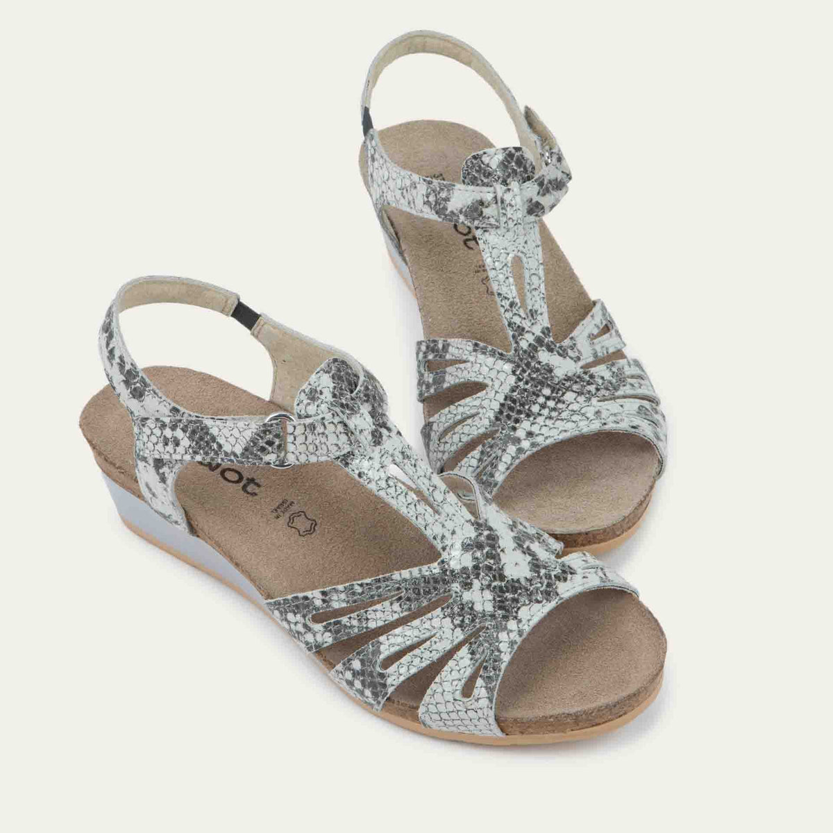 A pair of black wedge sandals with strappy design, open toe, and adjustable ankle strap on a cork footbed.