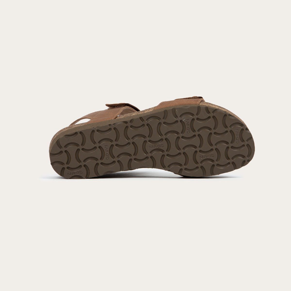 Bottom view of a brown leather sandal with two adjustable straps and a cork platform sole.