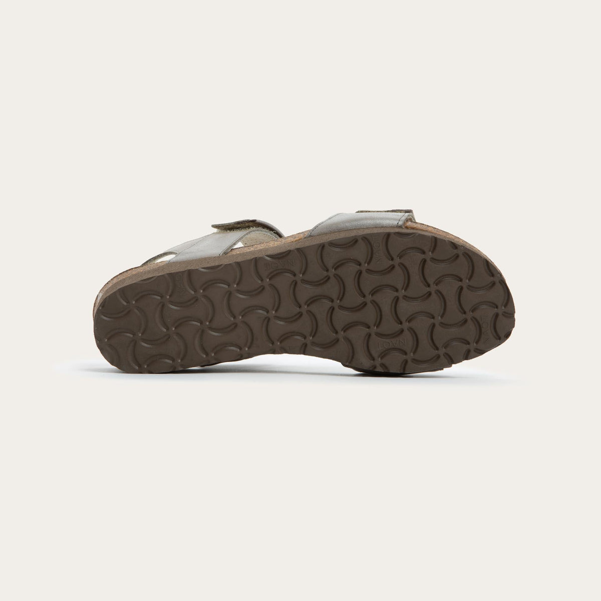 Bottom view of a silver leather sandal with two adjustable straps and a cork platform sole.