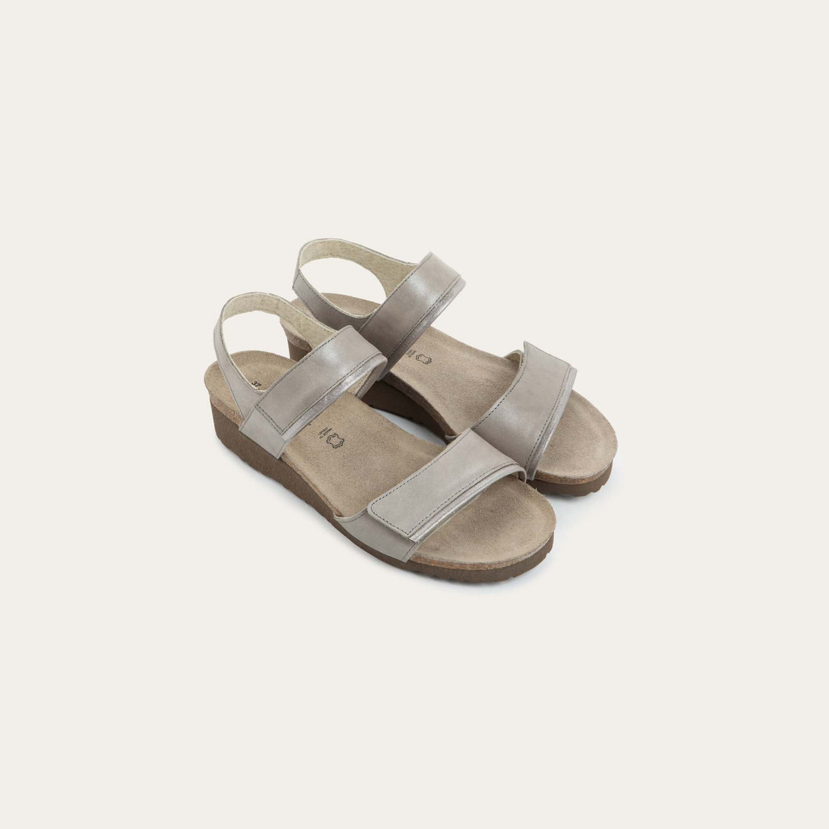 A pair of silver leather sandals with two adjustable straps and a cork platform sole.