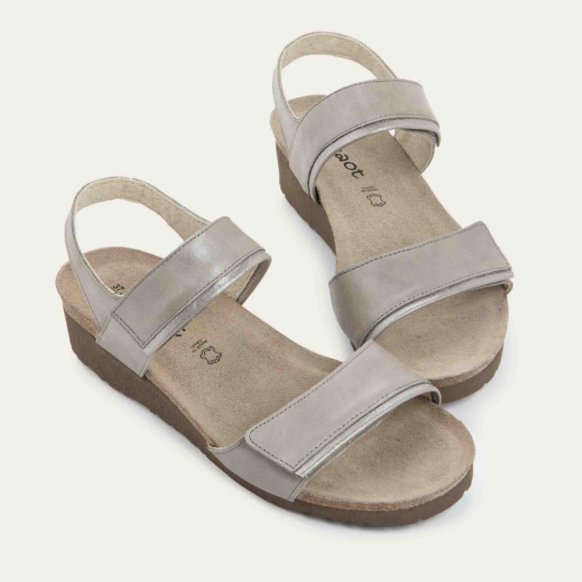 A pair of silver leather sandals with two adjustable straps and a cork platform sole.