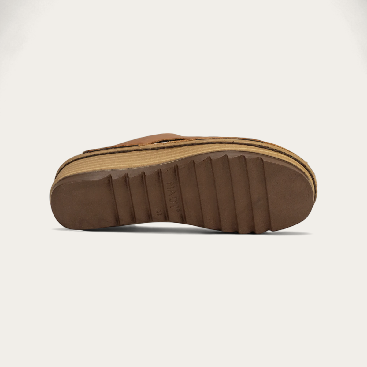 A brown slip-on sandal