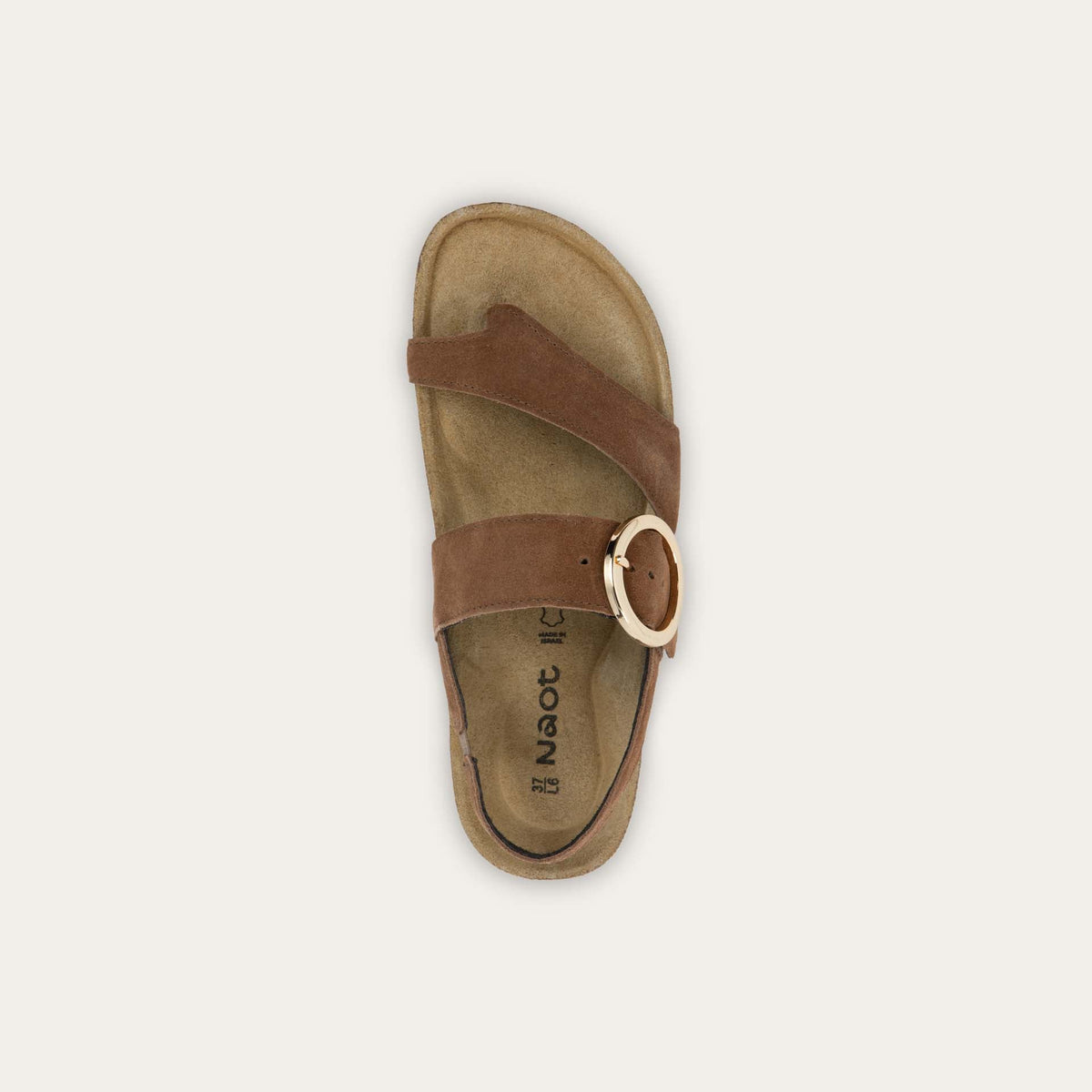 Top view of a brown strappy slide with an oversized buckle and a toe thong, featuring a cork sole.
