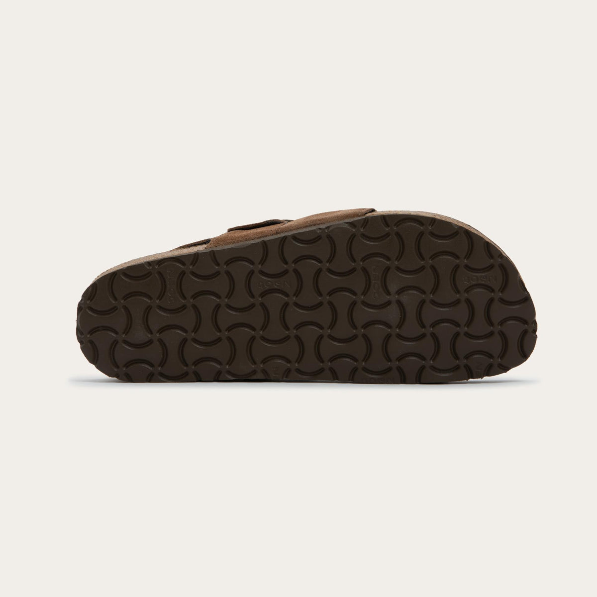 Bottom view of a brown strappy slide with an oversized buckle and a toe thong, featuring a cork sole.