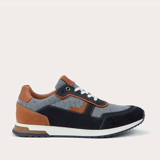 Profile view of a blue and brown sneaker featuring different materials on a white sole