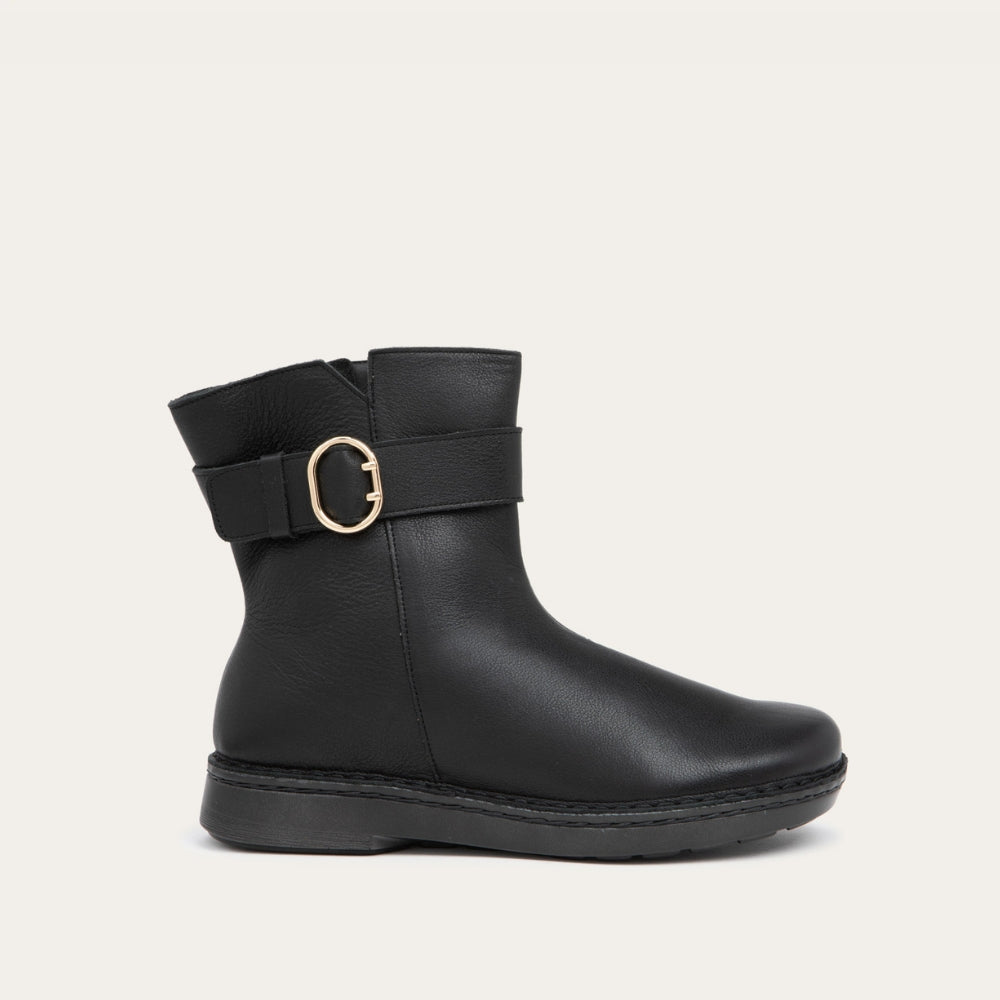 Profile view of a black calf boot with a simple strap and buckle detail