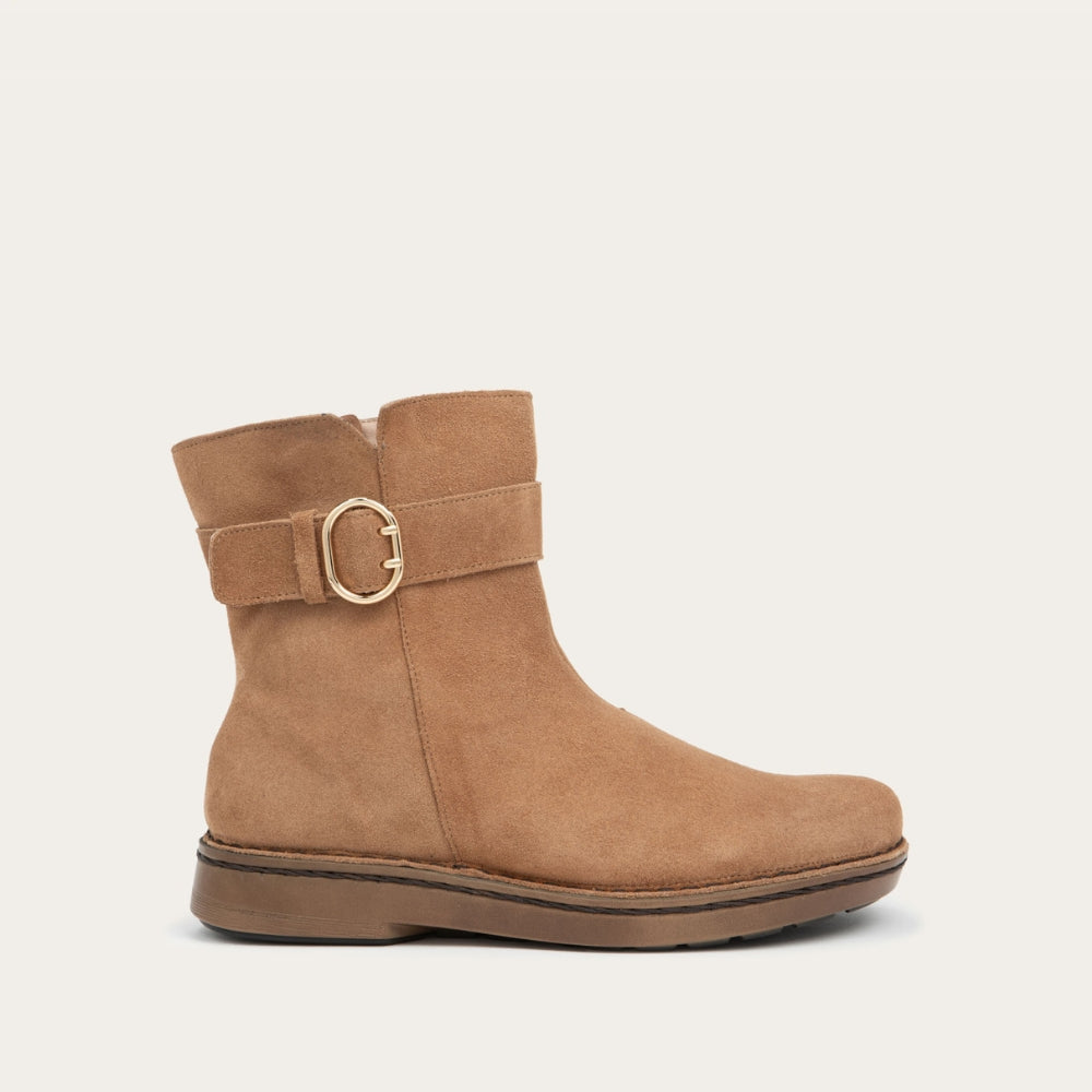 Profile view of a tan calf boot with a simple strap and buckle detail