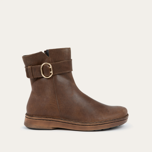 Profile view of a brown calf boot with a simple strap and buckle detail
