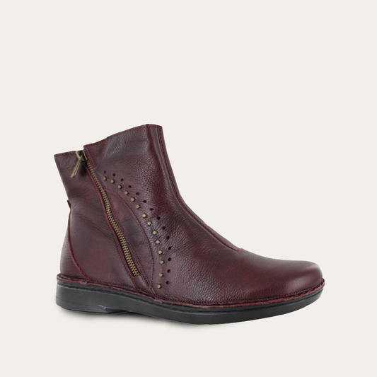 Maroon ankle boot with a zipper on a light gray background