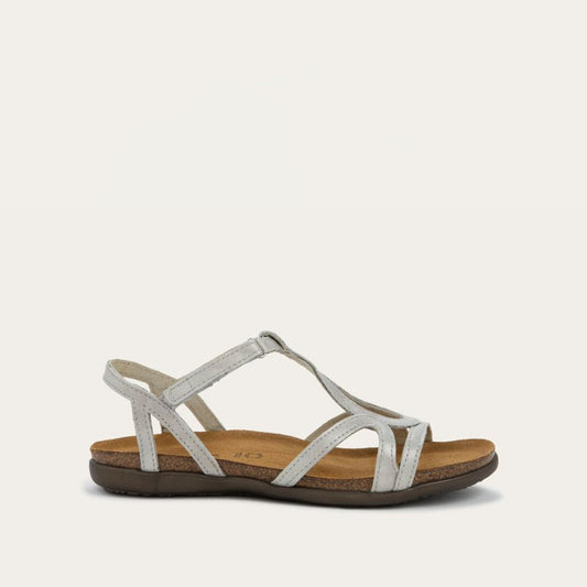 Profile view of a silver strappy sandal with an open-toe design and cork footbed on a brown sole