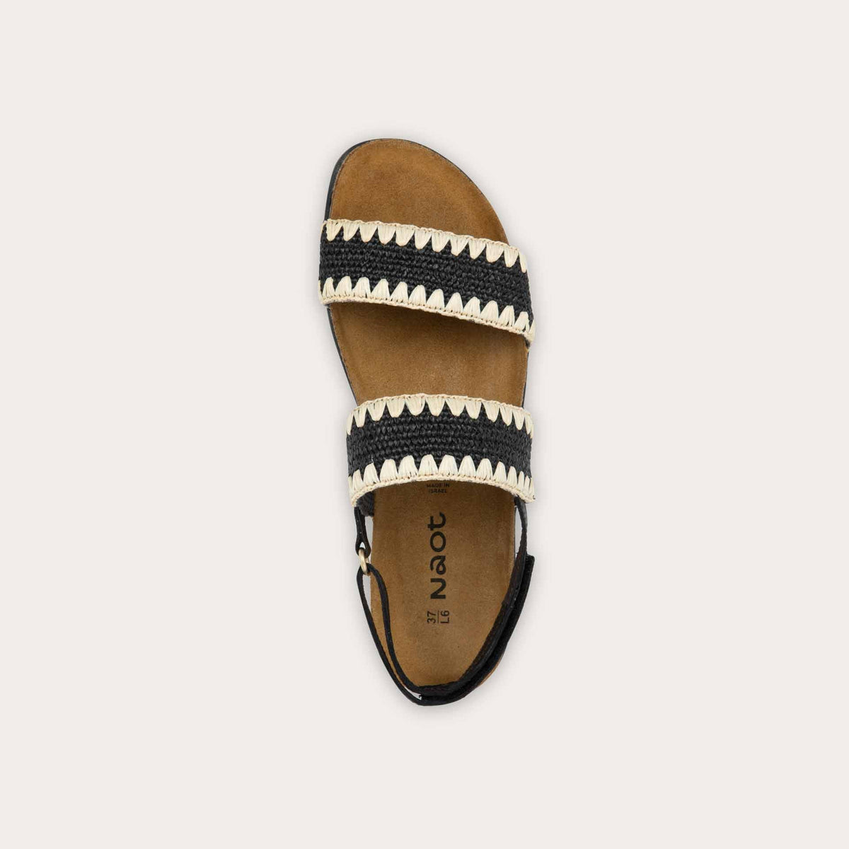 Top view of a black sandal featuring two textured toe straps and an adjustable ankle strap on a cork footbed.