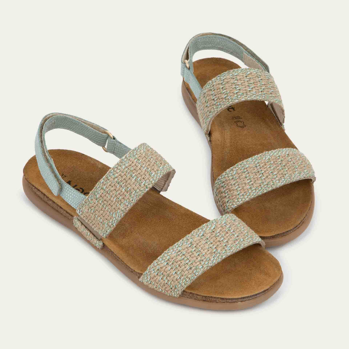 Pair of  green sandals featuring two textured toe straps and an adjustable ankle strap on a cork footbed.