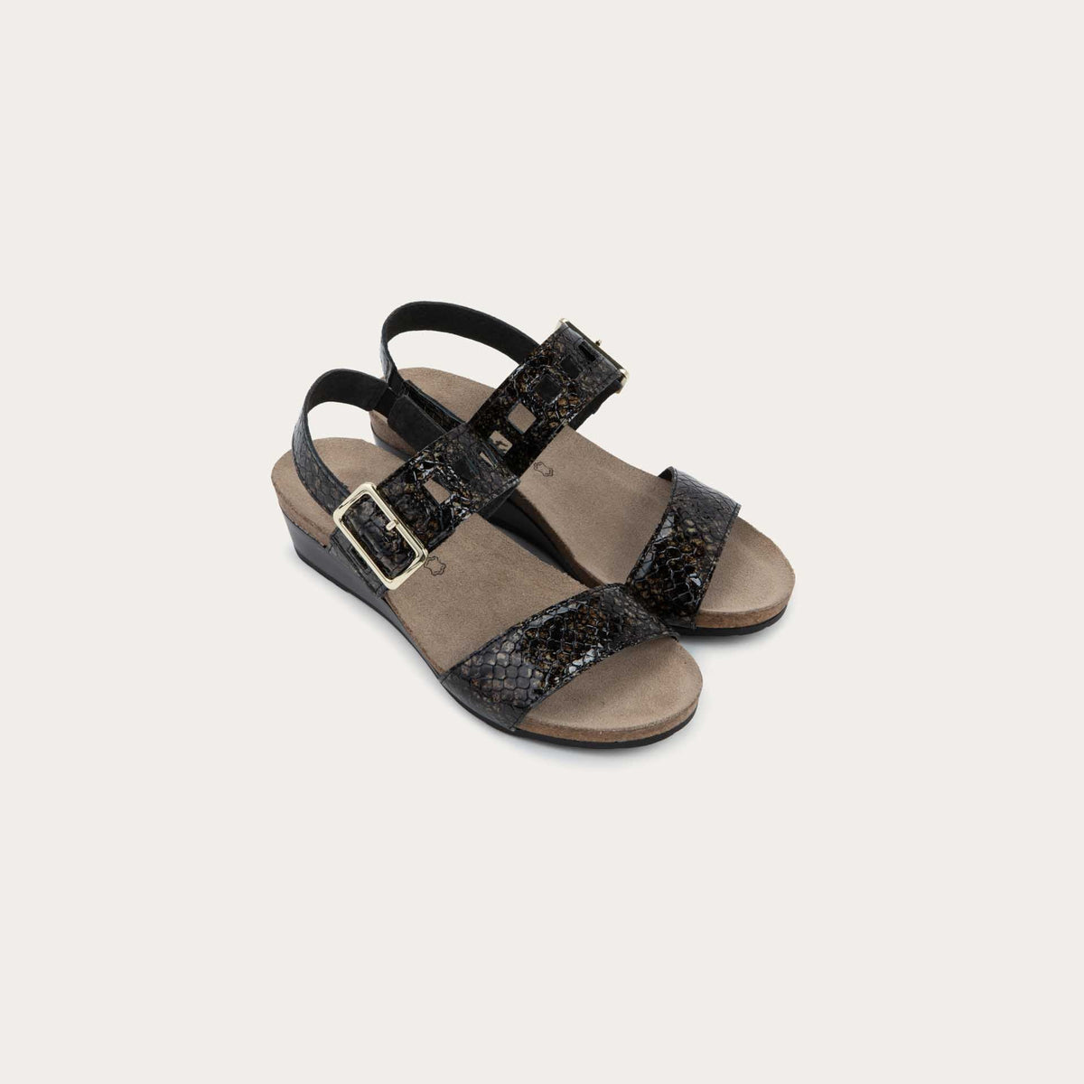Pair of black wedge sandals with a snakeskin design, featuring two straps and a metallic buckle with a cork footbed.