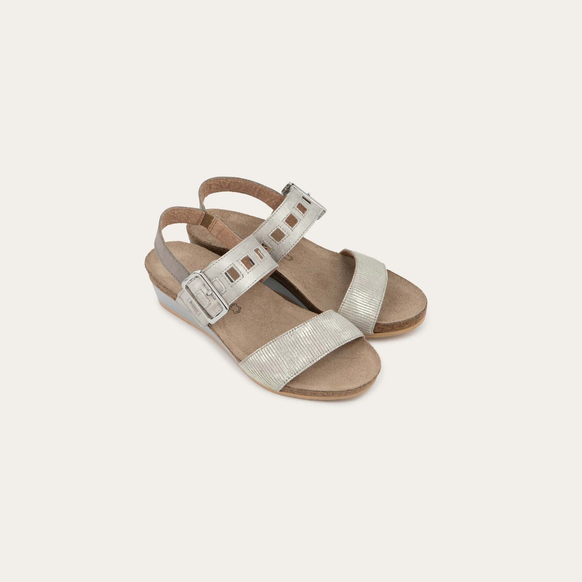 Pair of  grey/beige metalic wedge sandals, featuring two straps and a metallic buckle with a cork footbed