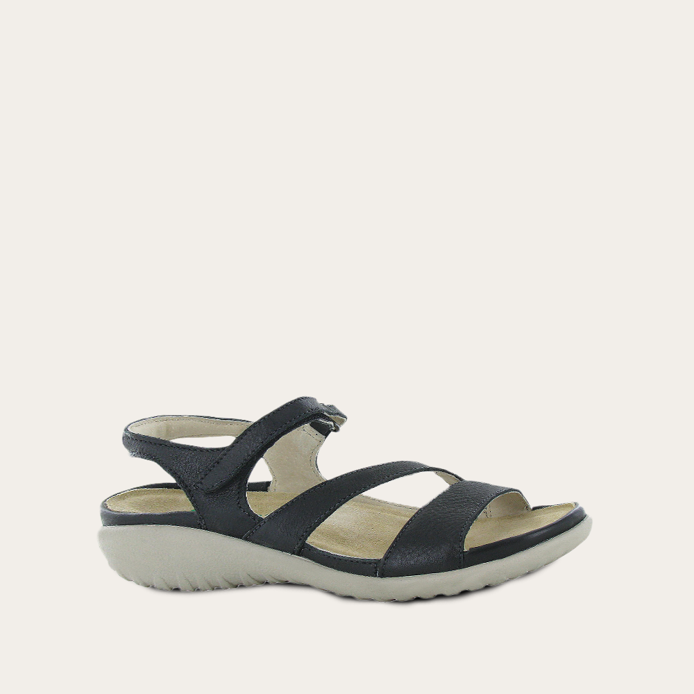 Black sandal with multiple straps on a light gray background