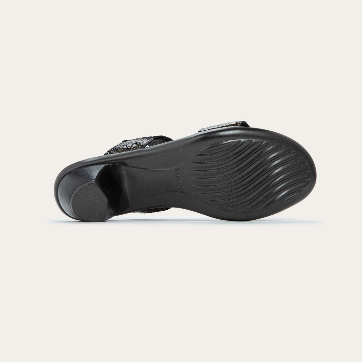 Bottom view of a slip-on t-strap reptile printed sandal with a mid-height heel .