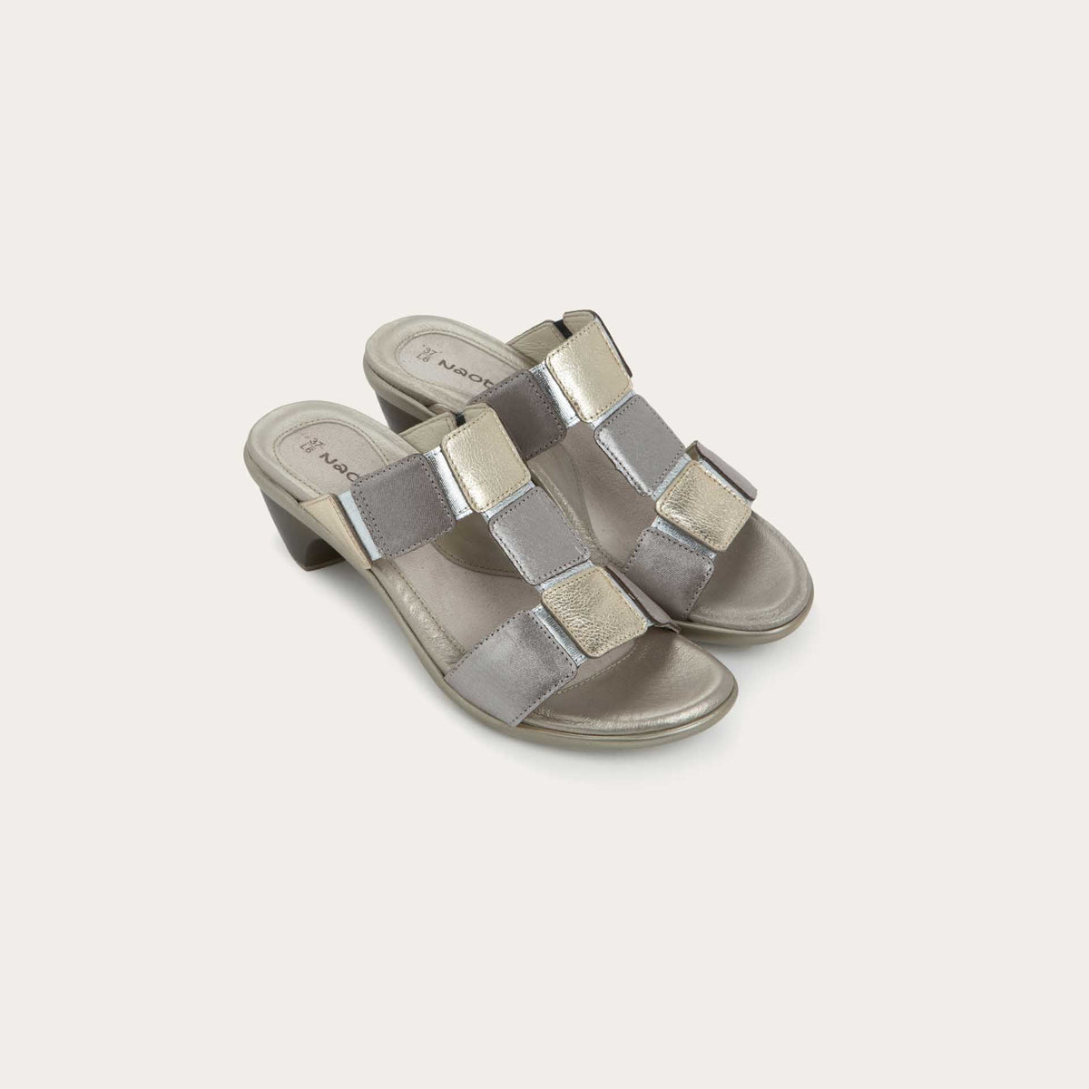 A pair of slip-on t-strap black sandals with a mid-height heel .