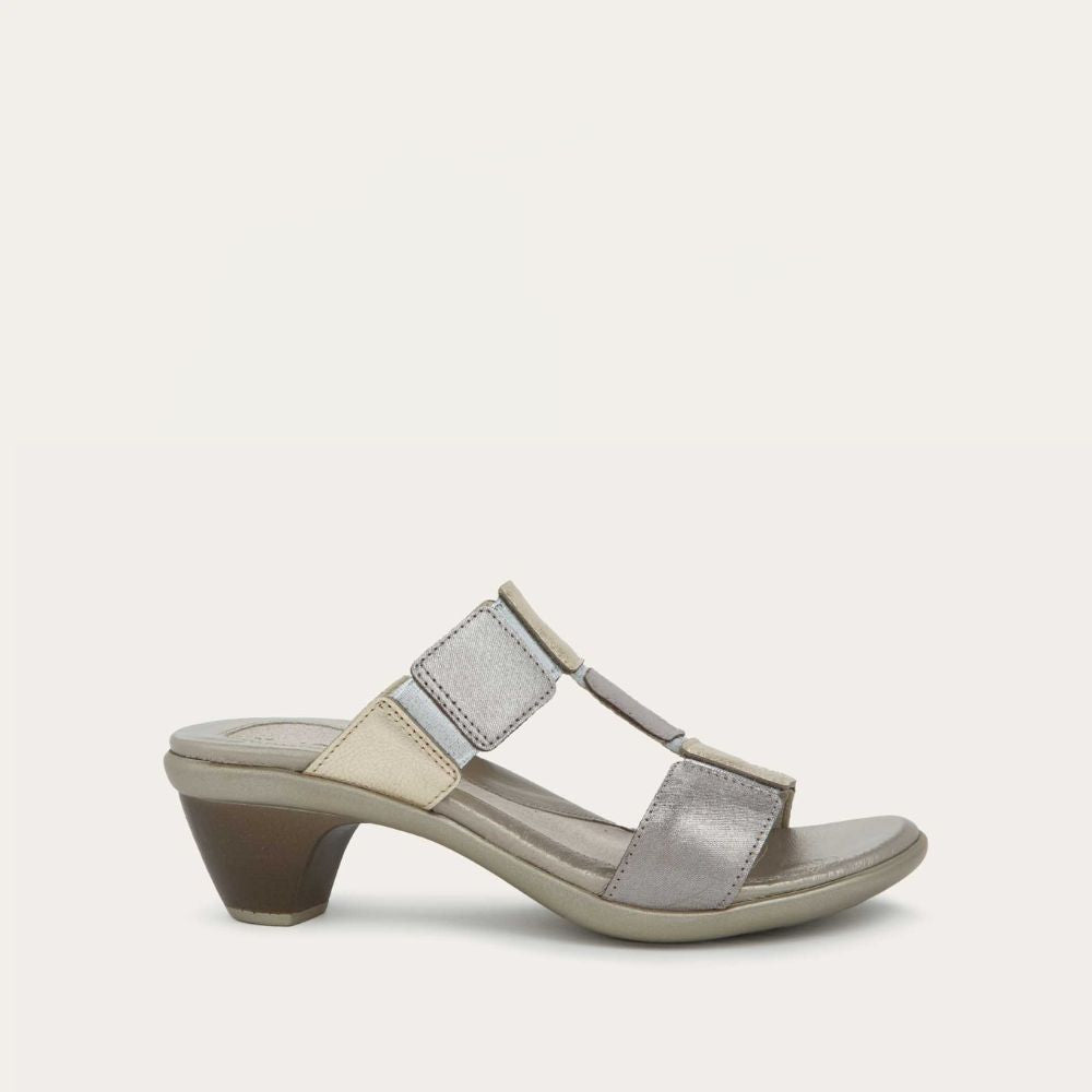 Profile view of a slip-on t-strap black sandal with a mid-height heel .