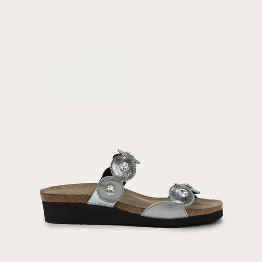 A brown and silver colored sandal with rhinestone accents and a wedge heel.