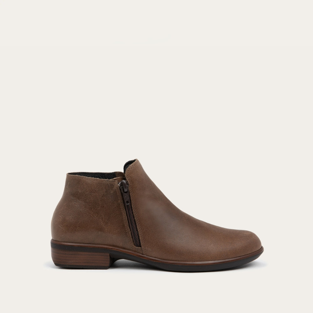 Side view of a brown bootie with a black and brown sole.