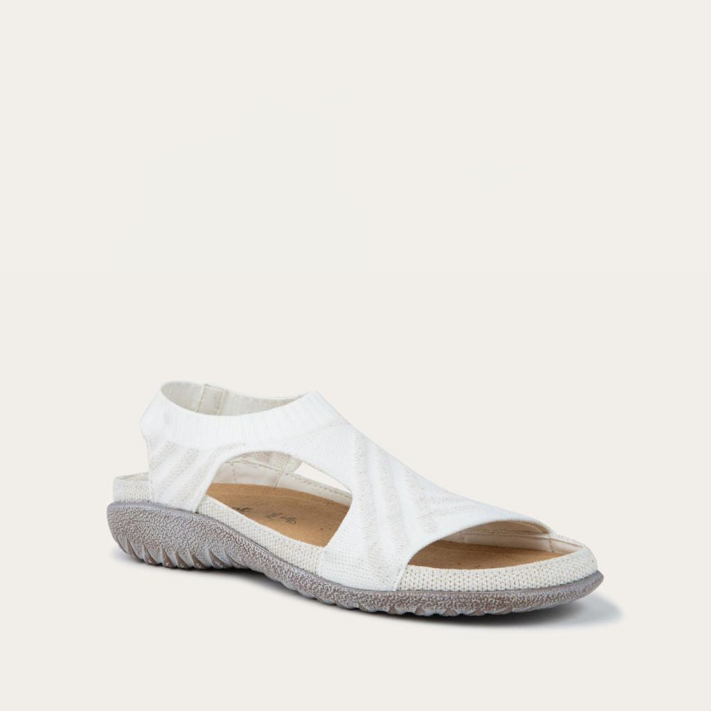 Bottom view of a white sparkle knit cutout sandal with open toes, elastic ankle strap, and black textured sole.