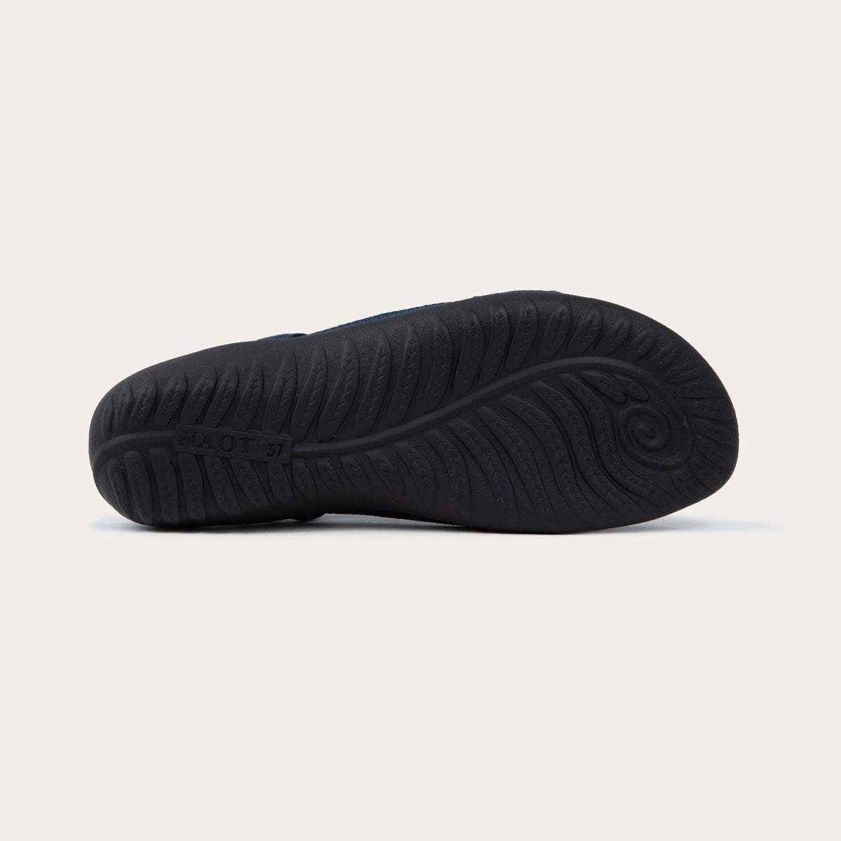 Bottom view of a navy knit cutout sandal with open toes, elastic ankle strap, and black textured sole.