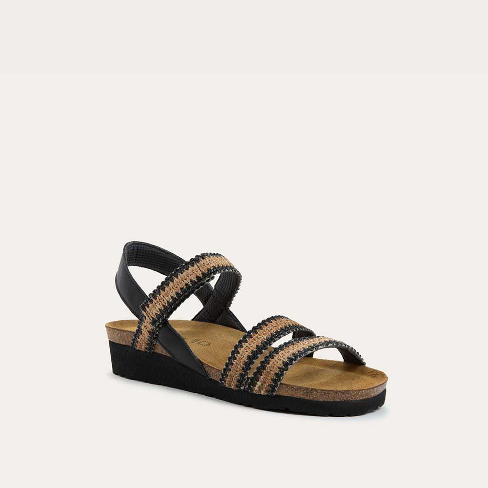 Angled profile view of black and brown raffia sandal with a cork footbed, black sole, and triple-strap design including a crisscross ankle strap.