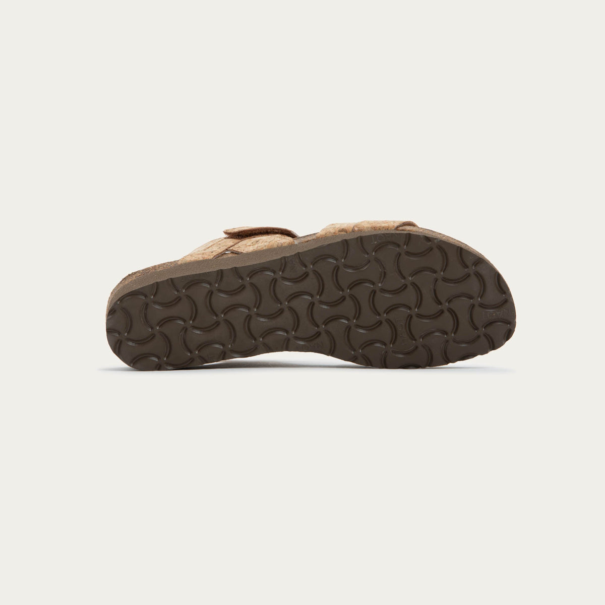 Bottom view of cork-leather sandal with a cork footbed, black sole, and triple-strap design including a crisscross ankle strap.