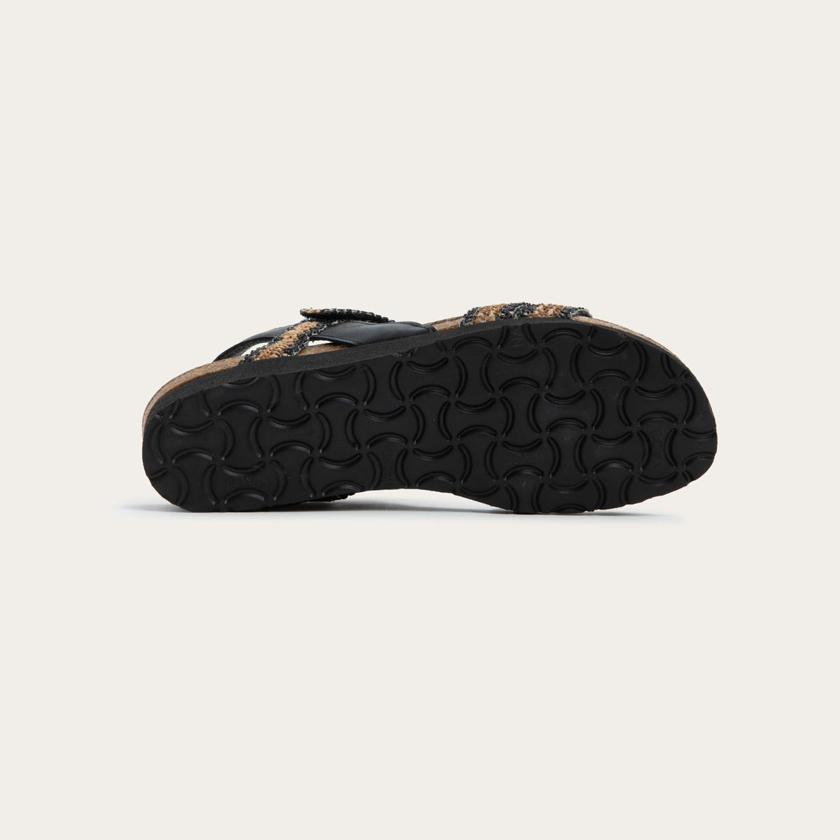 Bottom view of black and brown raffia sandal with a cork footbed, black sole, and triple-strap design including a crisscross ankle strap.