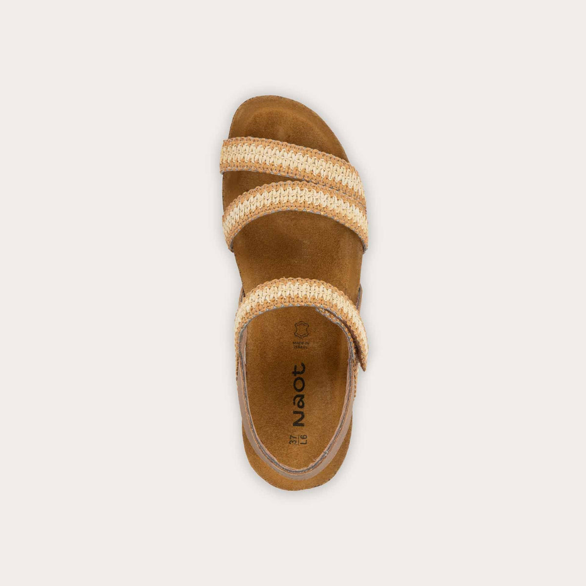 Top view of  brown and ivory raffia sandal with a cork footbed, black sole, and triple-strap design including a crisscross ankle strap.