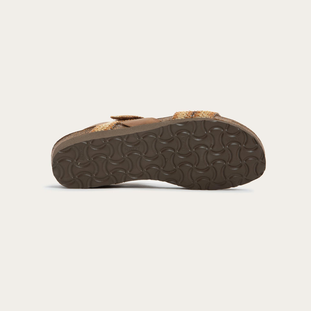 Bottom view of  brown and ivory raffia sandal with a cork footbed, black sole, and triple-strap design including a crisscross ankle strap.