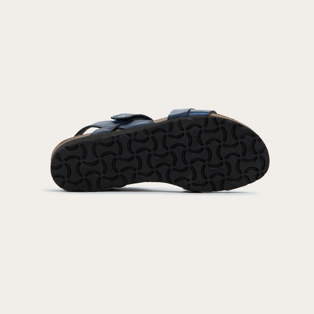 Bottom view of a navy blue sandal with a cork footbed, black sole, and triple-strap design including a crisscross ankle strap.