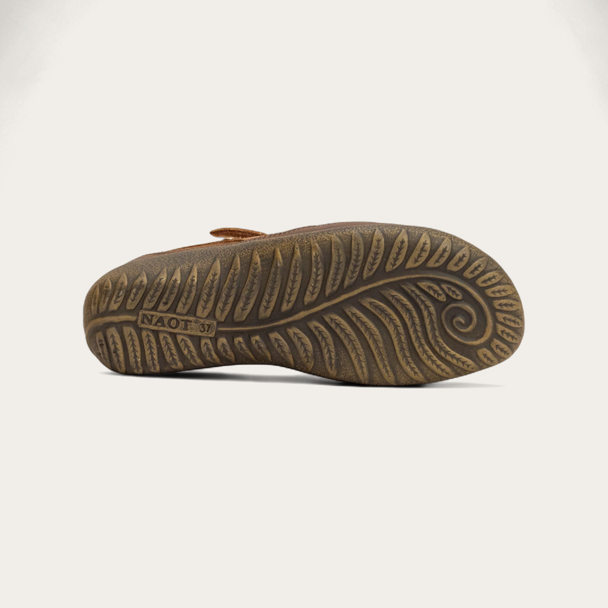 Bottom view of a brown leather Mary Jane shoe with a hook-and-loop strap