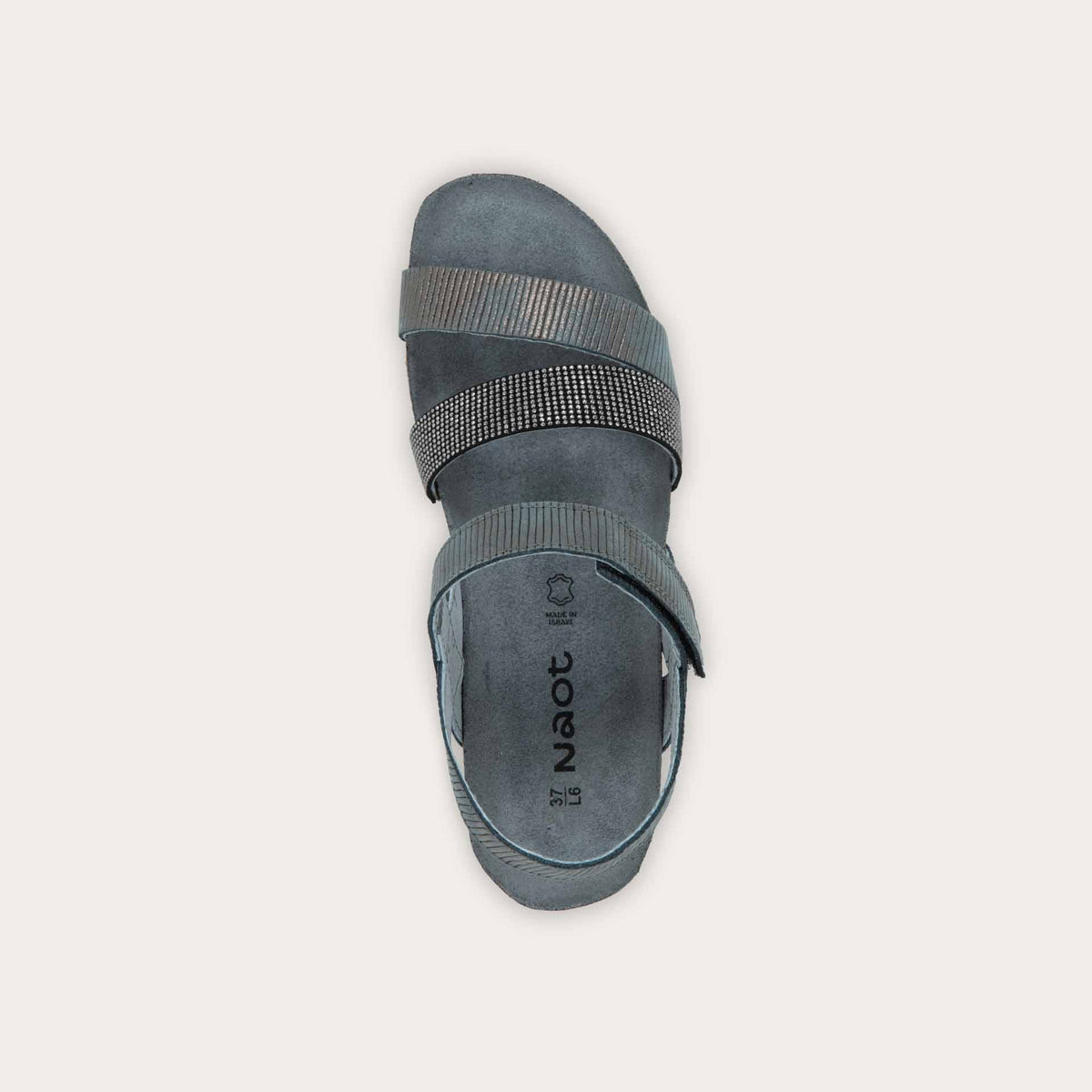 Top view of a gray sandal with two textured straps and a studded strap on a cork and black rubber sole,