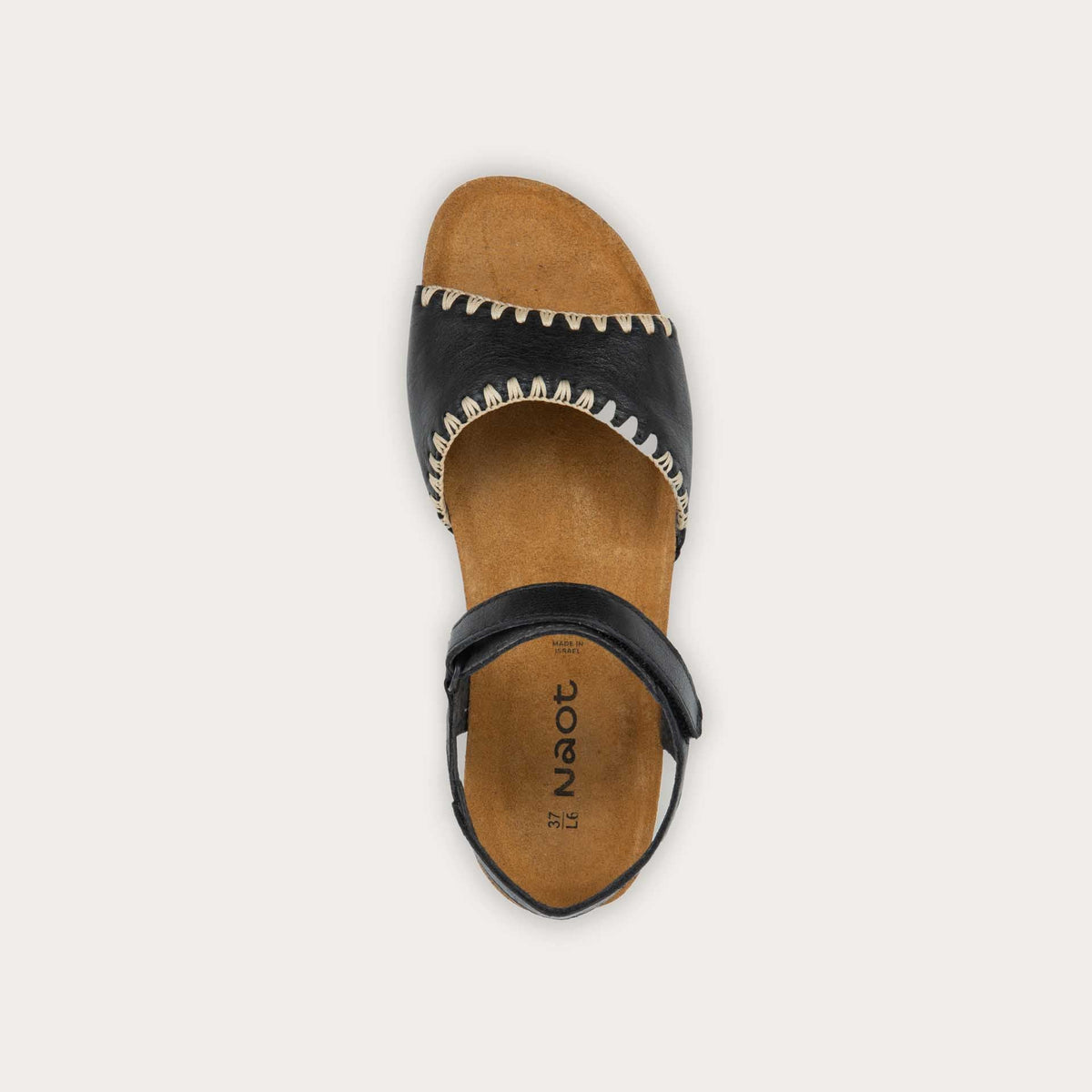 Top view of black and brown raffia sandal with a cork footbed, black sole, and triple-strap design including a crisscross ankle strap.