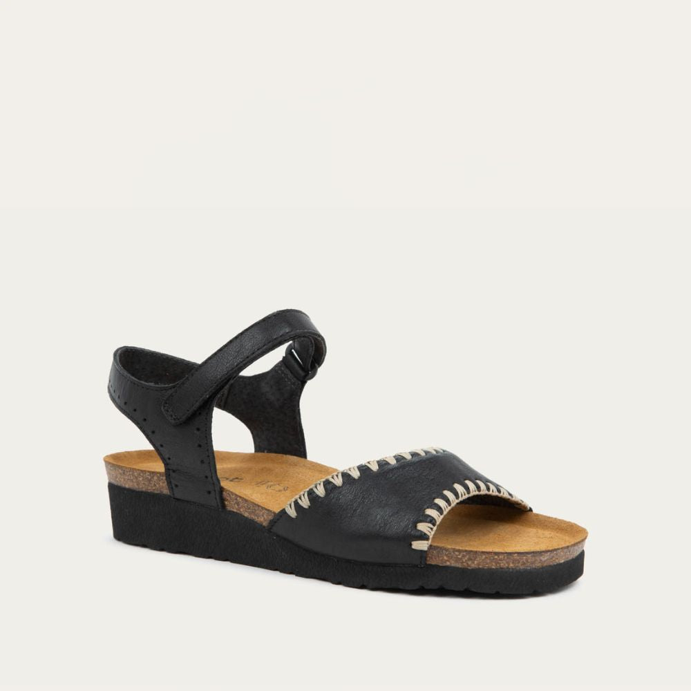 Angled profile view of black and brown raffia sandal with a cork footbed, black sole, and triple-strap design including a crisscross ankle strap.