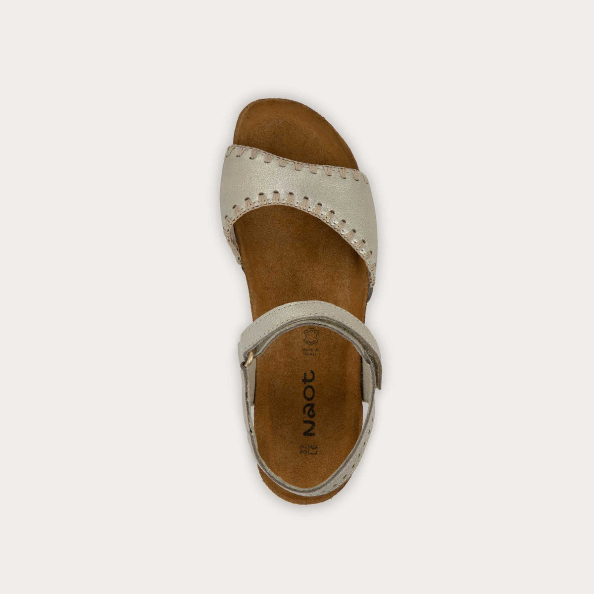 Top view of a gold sandal featuring a toe strap with contrast stitiching, adjustable ankle strap, and a cork footbed.