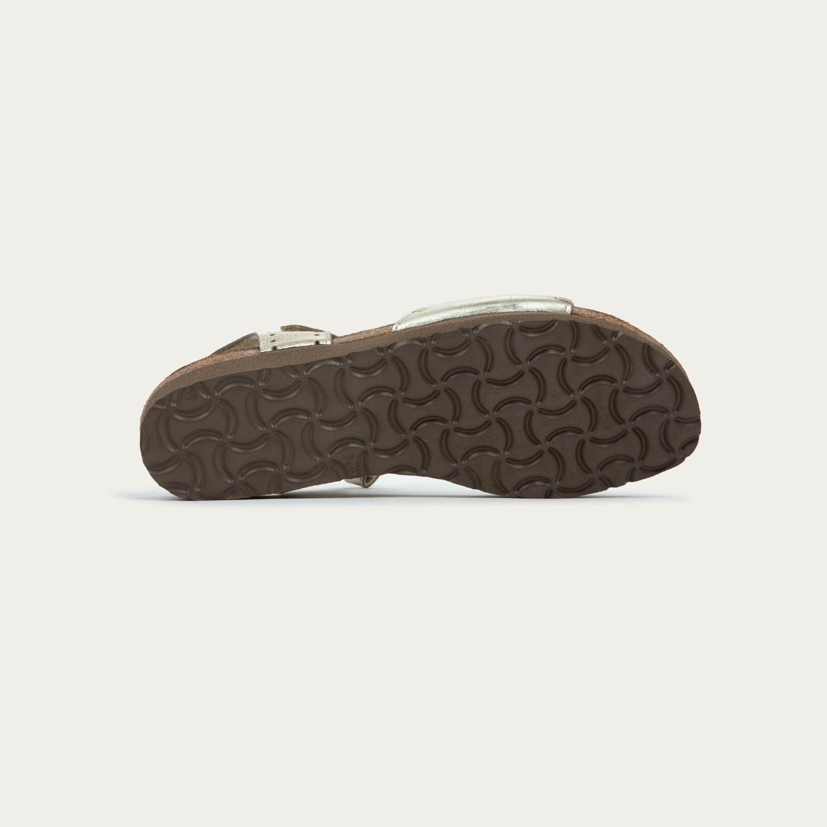 Bottom view of a gold sandal featuring a toe strap with contrast stitiching, adjustable ankle strap, and a cork footbed.