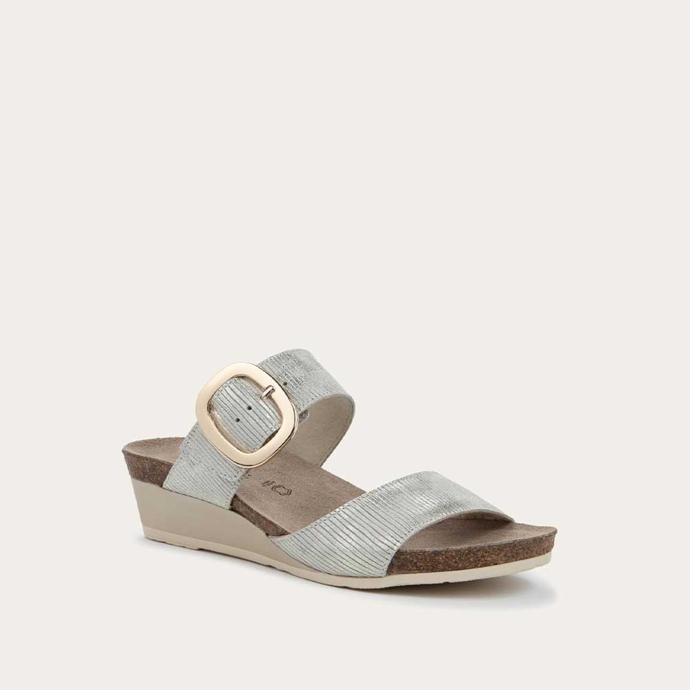 Angled profile view of a metallic gray textured wedge sandal with two straps and a large gold buckle. 