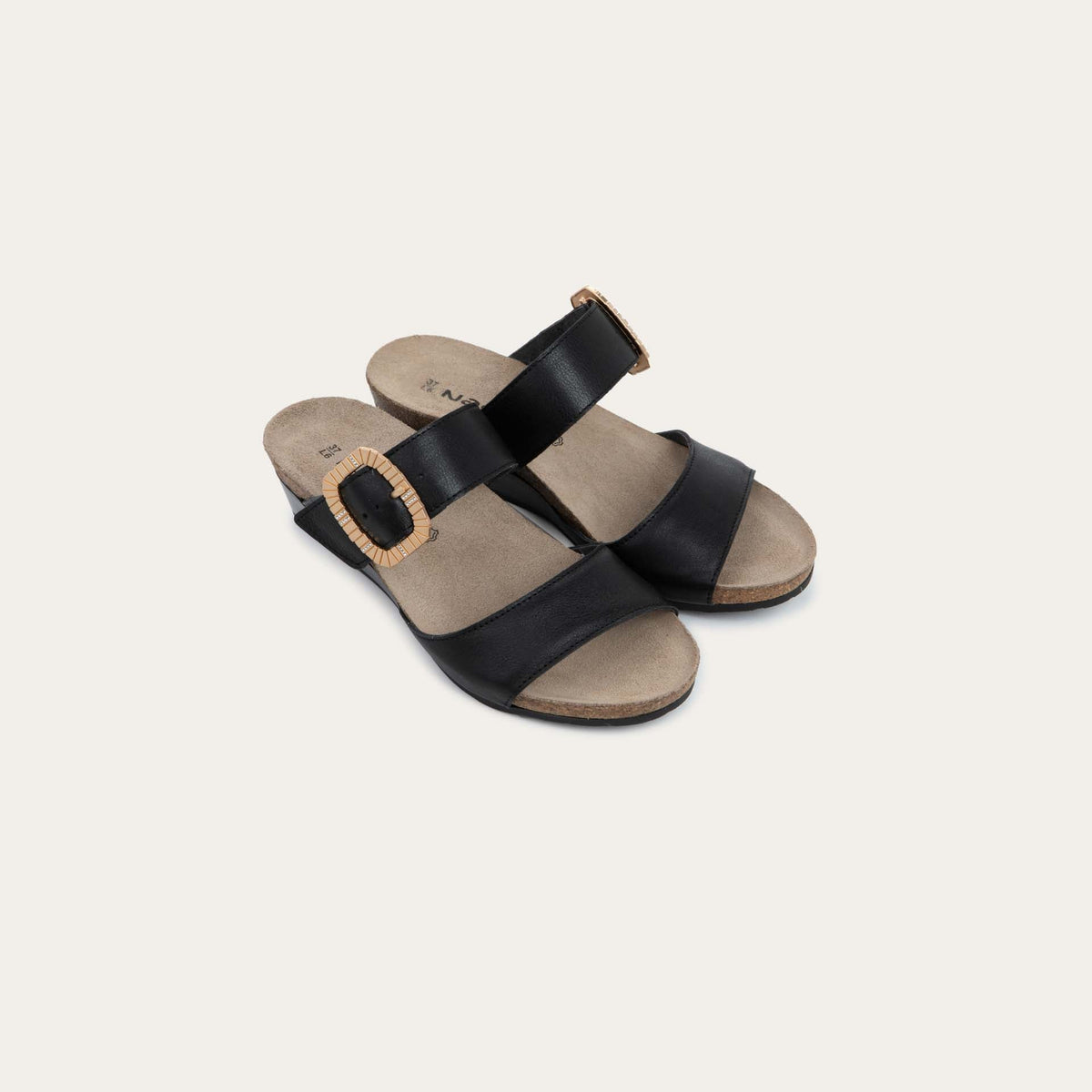 Pair of black slip-on wedge sandals with two straps and a large textured buckle. 