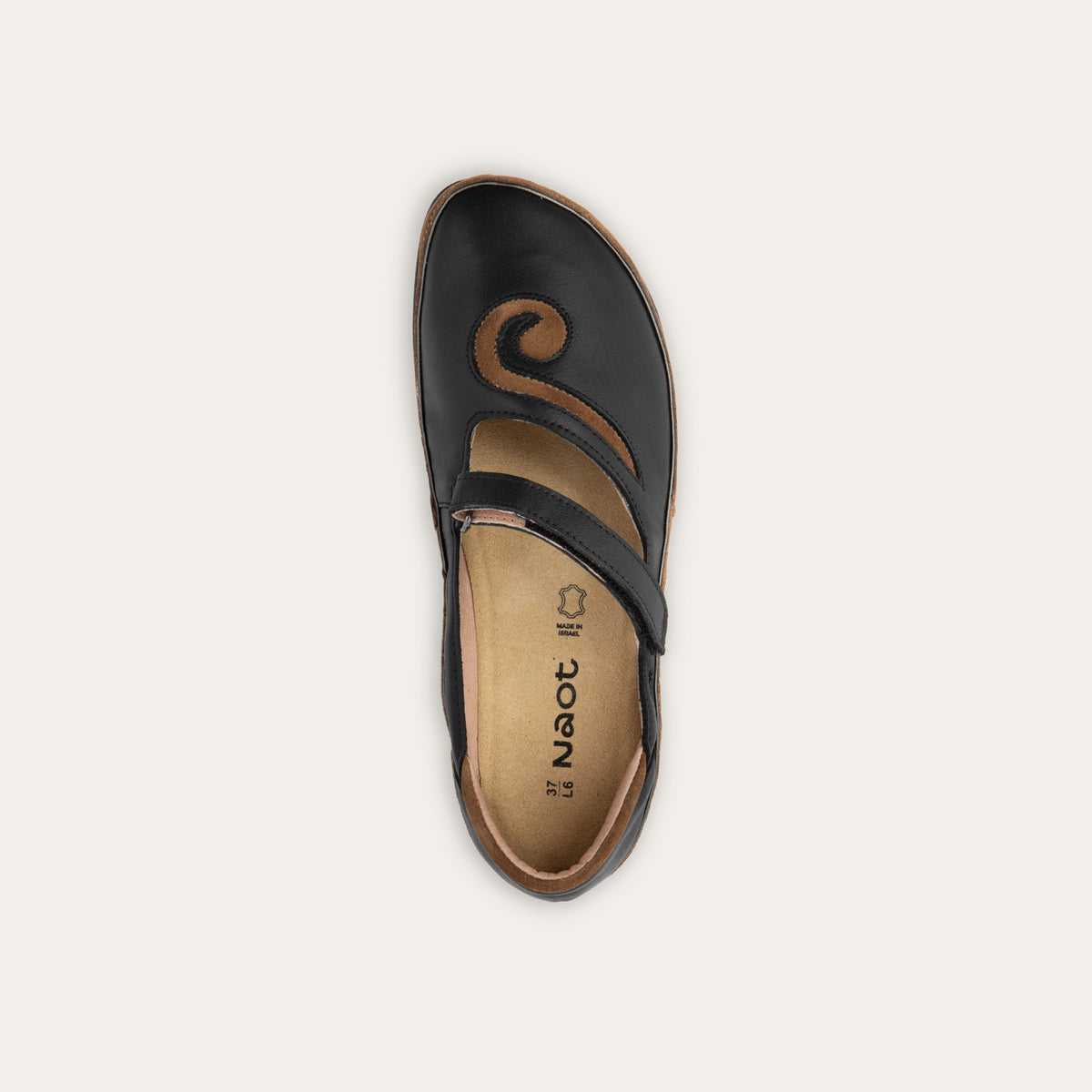 Top of a brown and black Mary Jane on a textured sole.