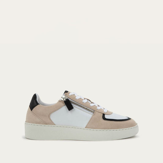 Profile view of a multicolored white, beige, and black sneaker with laces and a side zipper.