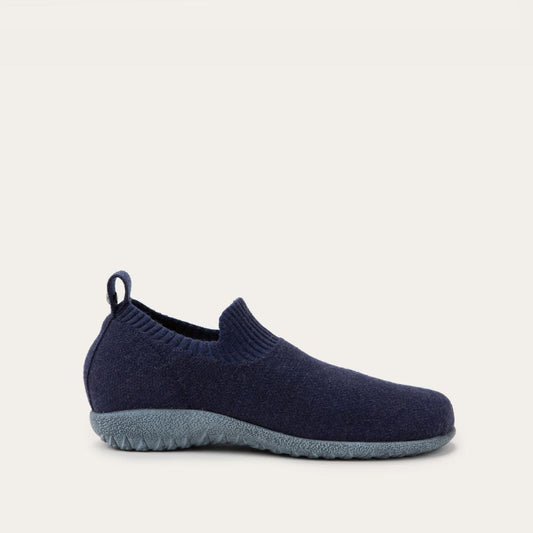 Profile view of a navy knit slip on shoe