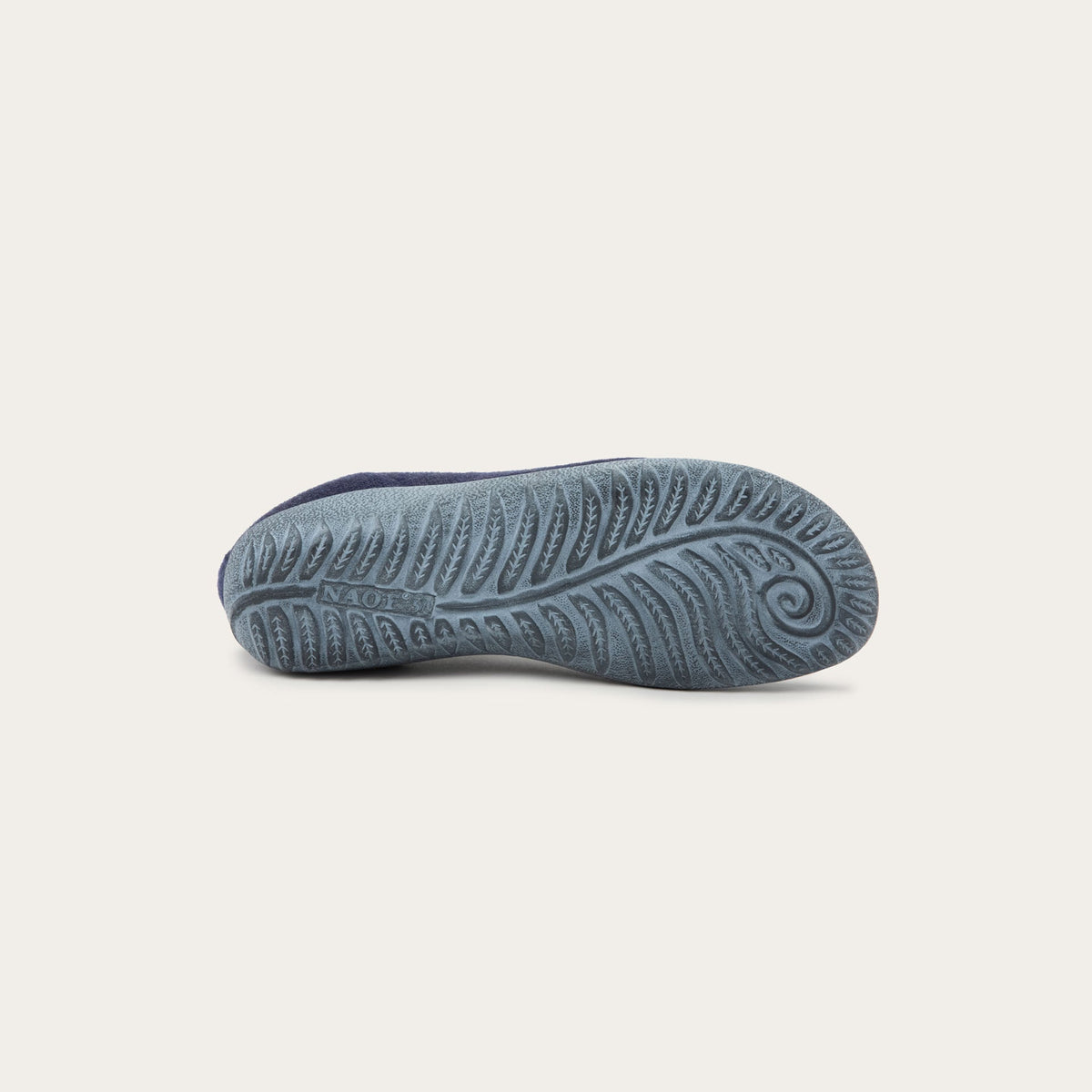 Bottom of a grey sole on a navy knit slip-on vegan shoe