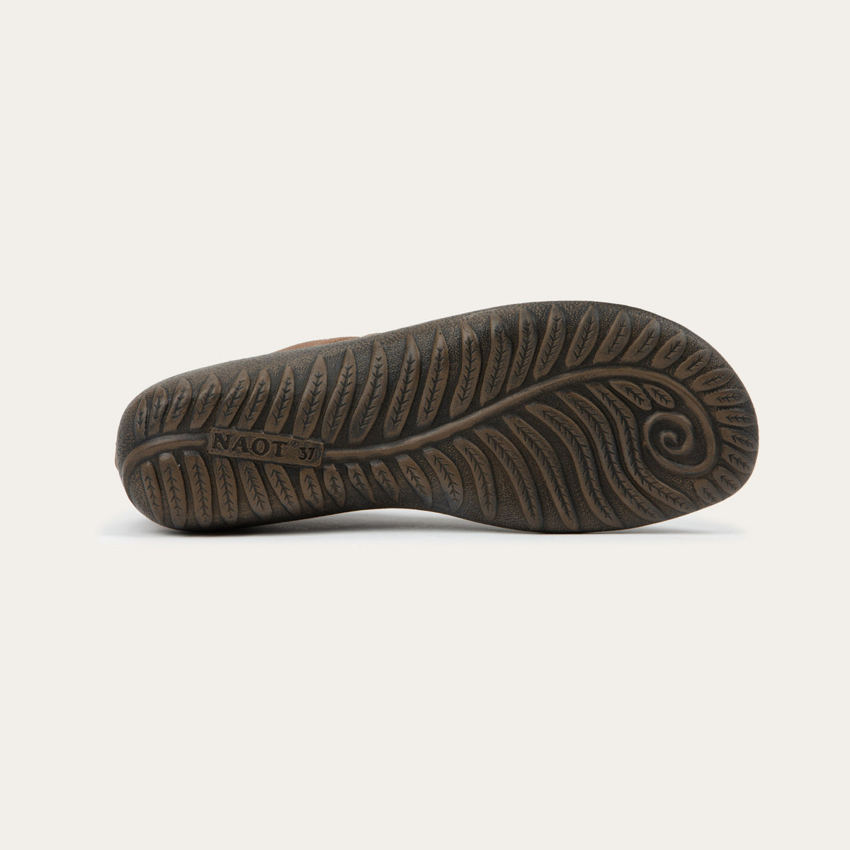 Bottom view of brown knit slip-on shoe on a gray sole