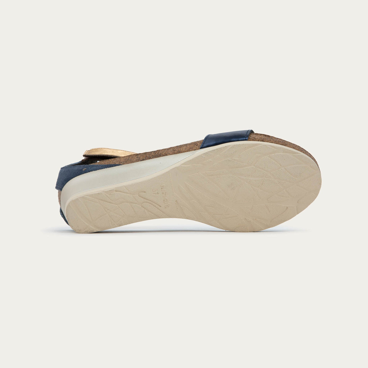 Bottom view of a blue wedge sandal with cork sole, featuring an open toe and metallic gold ankle strap.