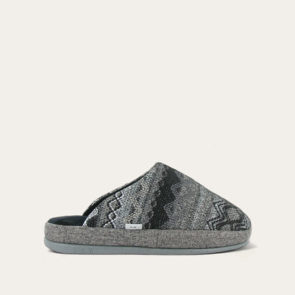 A gray and black geometric patterned slipper with a soft fleece lining.