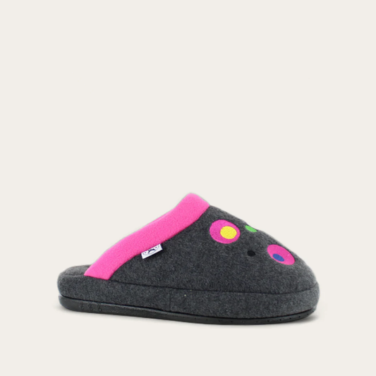 A slipper with a soft fleece lining and a colorful design, predominantly gray with pink trim and multicolored dots on the top.